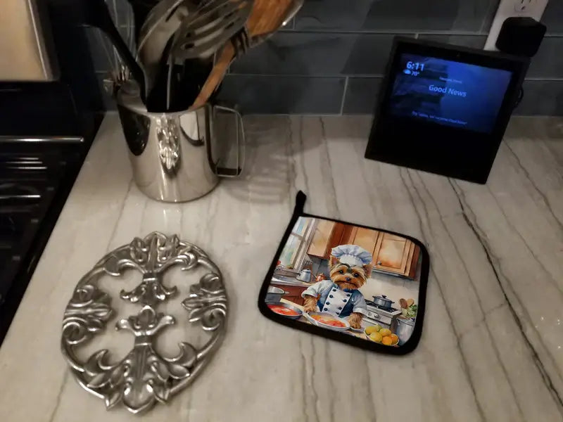 Colorful kitchen scene featuring a chef-themed pot holder and cooking utensils on a countertop.